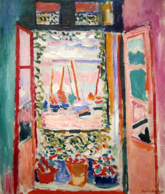 Open Window, Collioure by Henri Matisse: a window open onto a harbor with pink water and boats, framed by a teal wall on the left and pink and rust doors, with pots of flowers on the sill.